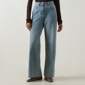 Model wearing Elena Miro Wide-Leg Jeans in light blue, high-rise with five-pocket styling, tobacco stitching and clean hems, styled with a dark brown