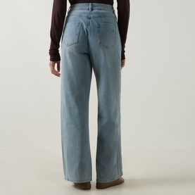 Model wearing Elena Miro Wide-Leg Jeans in light blue, high-rise with five-pocket styling, tobacco stitching and clean hems, styled with dark brown
