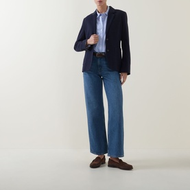 Model wearing Gant Single-Breasted Piqu&eacute; Blazer in blue, styled with a stripe shirt, wide-leg jeans and brown loafers.