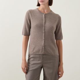 Model wearing Gant Brushed Knitted Cardigan in Sand, crew neck, short sleeves, button front, paired with tailored trousers