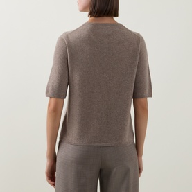 Model wearing Gant Brushed Knitted Cardigan in Sand, rear view, crew neck, short sleeves, paired with sand tailored trousers