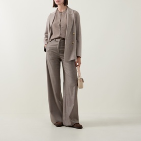Model wearing Gant Brushed Knitted Cardigan in Sand, styled with matching wide-leg trousers and blazer, carrying a small cream bag.