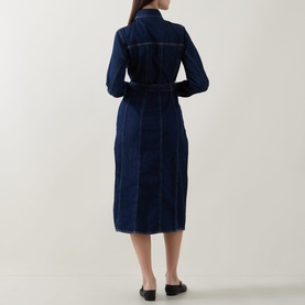 Model wearing Gant Dark Wash denim midi dress, rear view, belted waist, long sleeves, styled with black flat shoes.
