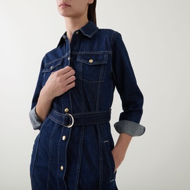 Model wearing Gant Dark Wash denim dress with gold-tone buttons, belted waist, chest pockets and rolled cuffs.