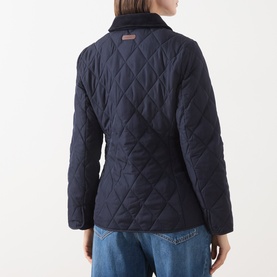 Model wearing Gant Quilted Fitted Jacket in blue, rear view, showing diamond-quilted shell and corduroy-trimmed collar, styled with jeans.