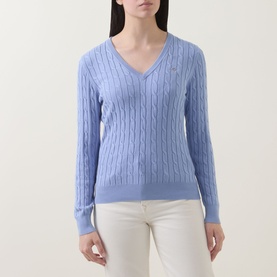 Model wearing Gant Shield Logo Cable Knit Sweater in Misty Lavender, V-neck cable knit with long sleeves, styled with white trousers.