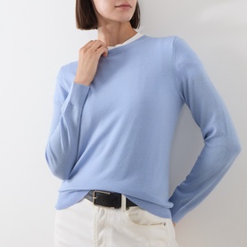 Model wearing Gant Merino Knitted Sweater in lavender with contrast crew neckline, paired with white jeans and black belt.