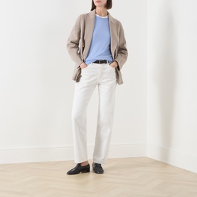Model wearing Gant Merino Knitted Sweater in Lavender with white jeans, a taupe blazer, and black loafers.