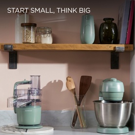 Kenwood Go MultiPro Food Processor in green, styled on a kitchen counter alongside a matching green stand mixer and wooden utensils