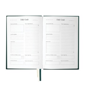 The Head Plan Undated Cloth Covered Journal in Forest Green, open to show Daily Goals pages with structured planning sections.