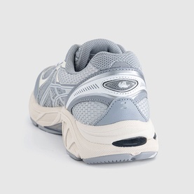 Asics trainer in Piedmont Grey and Glacier Grey, rear three-quarter view showing mesh upper, silver overlays, and chunky cream midsole