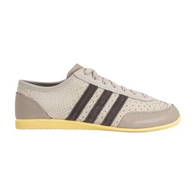 Adidas trainer in Wonder Beige with dark brown three stripes, perforated upper, suede heel panel, and yellow gum sole.