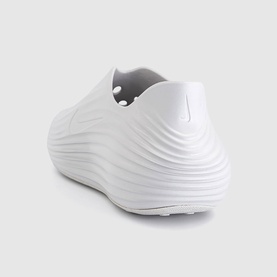Nike Vast Grey slip-on shoe with ribbed wave texture upper and chunky white sole, rear three-quarter view