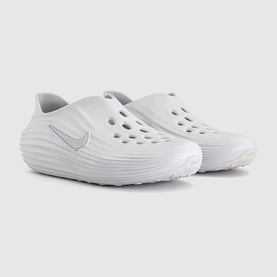 Nike slip-on clogs in vast grey with tonal Swoosh logo, perforated upper, and chunky ridged sole, pair shown together