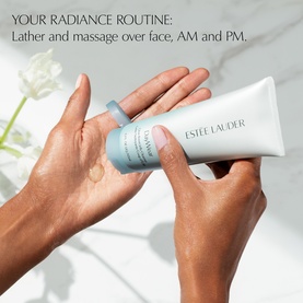 Estee Lauder DayWear Glow Boost Gel Cleanser Travel Size being dispensed from tube onto hand, with usage text overlay