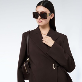 Model with Loewe Square Maxi Anagram Sunglasses in Havana, oversized tortoiseshell frames with gold-tone logo detail, styled with dark brown coat and