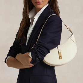 Model carrying Polo Ralph Lauren ivory shoulder bag with gold-tone hardware, styled with navy blazer and white shirt
