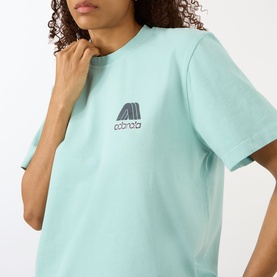 Model wearing Adanola Logo Graphic Oversized T-Shirt in Ocean Blue with Midnight Blue chest logo graphic and round neck.