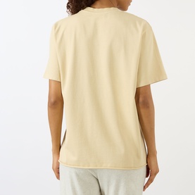 Model wearing Adanola Logo Graphic Oversized T-Shirt in Caramel Beige, back view, round neck, short sleeves, styled with matching joggers.