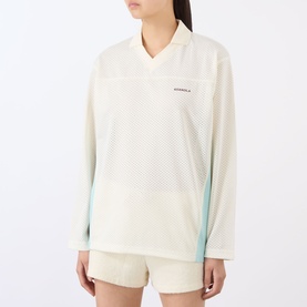 Model wearing Adanola top in Marshmellow White with mesh panel detail, V-neck, long sleeves and mint side panels, styled with cream shorts.