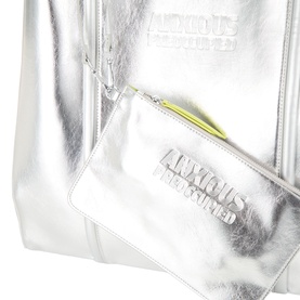 Anxious Preoccupied The Oversized Logo Tote Bag in silver metallic finish with lime green zip detail, debossed logo branding, shown with matching