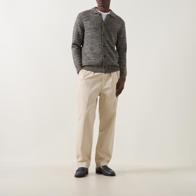 Model wearing Aspesi Textured Knitted Polo Cardigan in Military, styled with cream trousers and navy loafers.