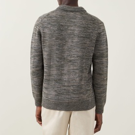 Model wearing Aspesi Textured Knitted Polo Cardigan in Military, back view, styled with cream trousers.