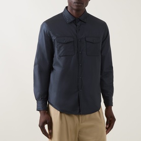 Model wearing Aspesi navy nylon casual jacket with twin chest pockets and button front, styled with stone chinos.