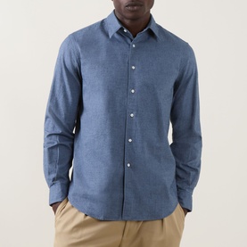 Model wearing Aspesi light blue cotton casual shirt with spread collar and white buttons, styled with khaki trousers