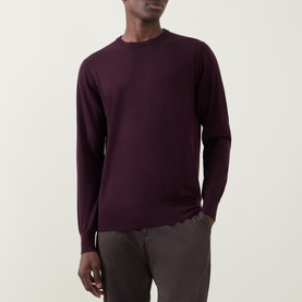 Model wearing Aspesi Fine-Knit Sweater in burgundy wool, crew neck with ribbed trims and long sleeves, styled with grey trousers.