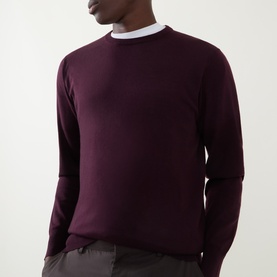 Model wearing Aspesi Fine-Knit Sweater in burgundy wool, crew neck with ribbed trims and long sleeves, styled with grey trousers.