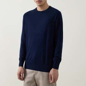 Model wearing Aspesi Solid Wool Sweater in Black Navy, crew neck with ribbed trims and long sleeves, styled with beige trousers.