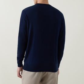 Model wearing Aspesi Solid Wool Sweater in Black Navy, crew neck with ribbed trims, long sleeves, styled with beige trousers. Rear view.