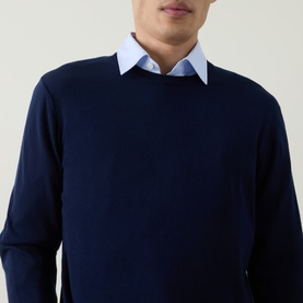 Model wearing Aspesi Solid Wool Sweater in Black Navy, crew neck, 100% wool, styled with a light blue collared shirt underneath.