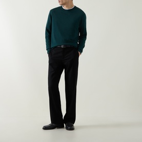 Model wearing Aspesi Solid Wool Sweater in green with crew neck, styled with black trousers and a belt.