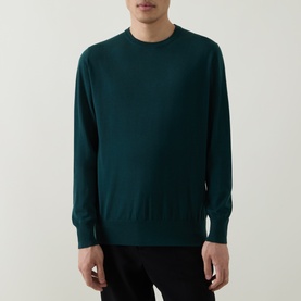 Model wearing Aspesi Solid Wool Sweater in green, crew neck with ribbed trims, paired with black trousers.