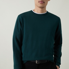 Model wearing Aspesi Solid Wool Sweater in green, crew neck with ribbed trims, styled with a white collar and black belt.