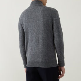 Model wearing Aspesi Solid Half-Zip Sweater in grey, rear view, showing funnel neck and ribbed hem, styled with navy trousers.