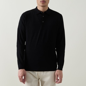 Model wearing Aspesi Solid Knitted Polo Shirt in black, long sleeves, buttoned collar, paired with cream trousers.