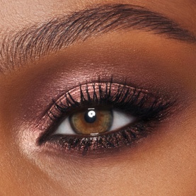 Charlotte Tilbury Eye Shadow in Oyster Twilight, a smoky rose-bronze metallic eyeshadow look shown on model's eye with defined liner