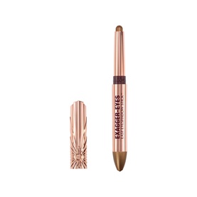 Charlotte Tilbury Exagger-Eyes Eyeshadow Stick in Oyster Twilight, rose gold barrel with cap shown alongside pencil tip