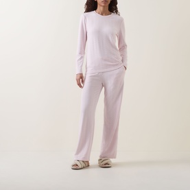 Model wearing Gingerlilly Ellie Lightweight Velour Cable Knit Pyjama Set in Ellie Pink, styled with fluffy slippers
