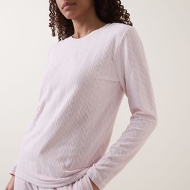 Model wearing Gingerlilly Ellie Lightweight Velour Cable Knit Pyjama Set in Ellie Pink, showing long-sleeve cable knit top with round neckline