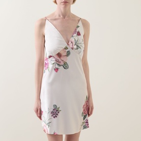 Model wearing Gingerlilly Piper Floral Satin Night Dress in Ivory, deep V-neck, narrow straps, mini length with placement floral print.