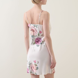 Model wearing Gingerlilly Piper Floral Satin Night Dress in Ivory, showing back view with adjustable straps and pink floral print mini length skirt.