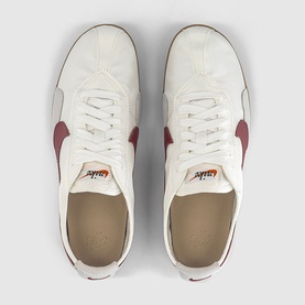 Nike Moon Shoe Trainers in summit white and team crimson, overhead view showing nylon upper, leather Swoosh logo and waffle rubber sole.