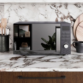 Morphy Richards Cassini 20L 800w Black Microwave on marble kitchen countertop with dark wood cabinetry and styled accessories