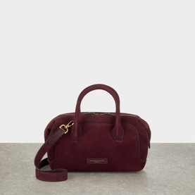 Gianni Chiarini burgundy suede crossbody bag with gold-tone hardware, rolled top handles, and detachable shoulder strap.