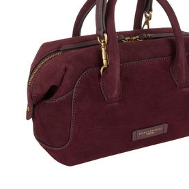 Gianni Chiarini burgundy suede crossbody bag with gold-tone zip hardware and dual top handles, close-up detail view