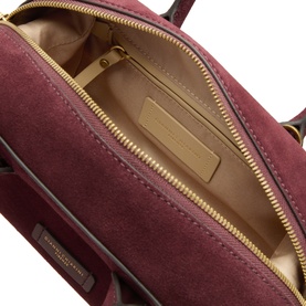 Gianni Chiarini burgundy suede crossbody bag interior view showing zip pocket, gold-tone zip and neutral fabric lining